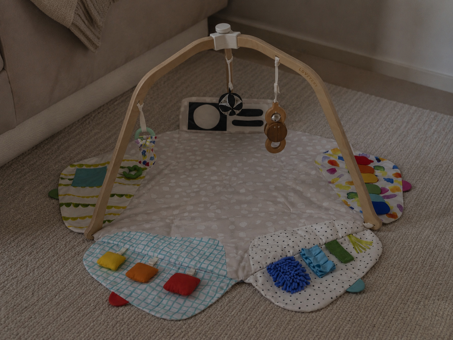 Our Lovevery play gym set up on the living room floor, original photo
