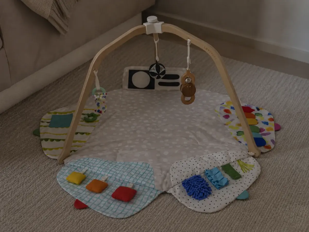 Our Lovevery play gym set up on the living room floor, original photo