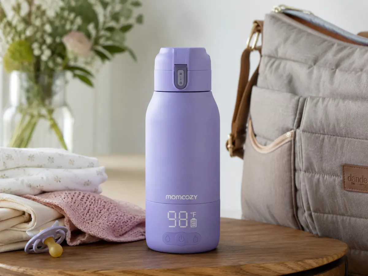 Our Momcozy portable bottle warmer warming a bottle on the go, original photo