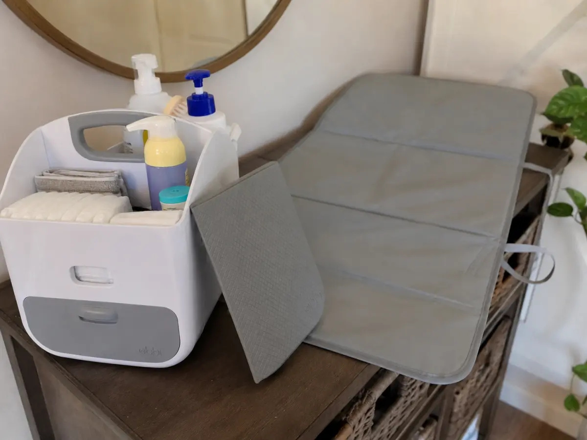 Our Ubbi portable diaper caddy stocked and ready on the dresser, original photo